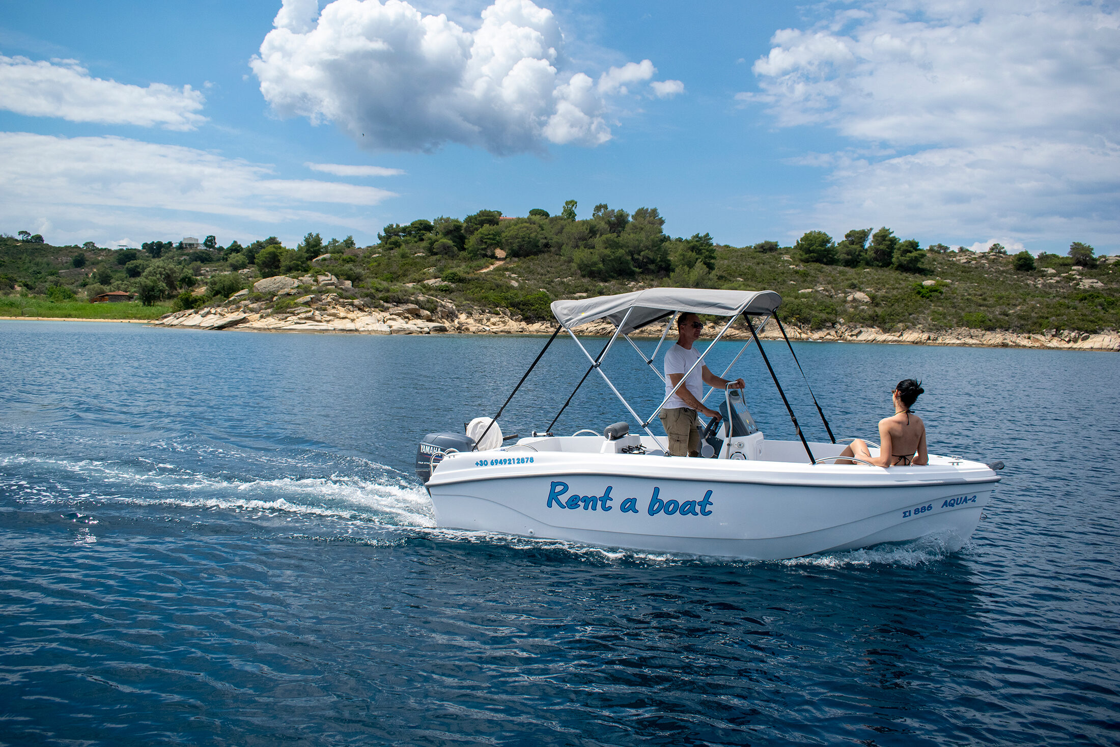 Boats anchored in the shallow turquoise Blue Lagoon between Diaporos and the islets